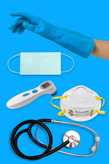 medical equipment needed to prevent the spread of coronavirus. surgical mask, stethoscope, glove on blue background