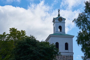 Fototapeta na wymiar A clocktower of church of The Holy Cross in Rauma, Finland.