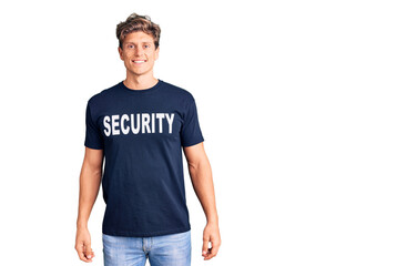 Fototapeta premium Young handsome man wearing security t shirt with a happy and cool smile on face. lucky person.