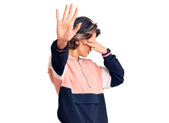 Young beautiful woman wearing sportswear covering eyes with hands and doing stop gesture with sad and fear expression. embarrassed and negative concept.