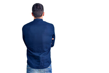 Young handsome man wearing casual shirt standing backwards looking away with crossed arms