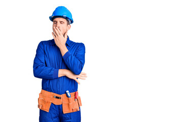 Young handsome man wearing worker uniform and hardhat bored yawning tired covering mouth with hand. restless and sleepiness.