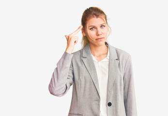 Young beautiful blonde woman wearing elegant jacket shooting and killing oneself pointing hand and fingers to head like gun, suicide gesture.