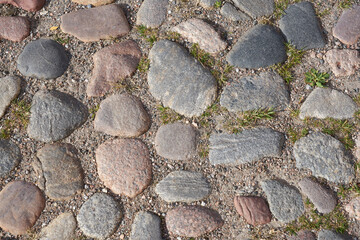 Texture of stone pavement tiles on a road.