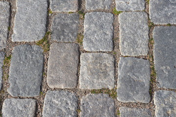 Texture of stone pavement tiles on a road.