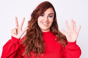 Young beautiful woman wearing casual clothes showing and pointing up with fingers number eight while smiling confident and happy.