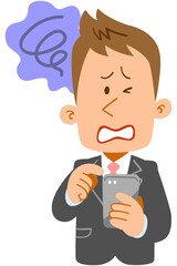 スマートフォンを操作する若いビジネスマンの不満の表情
