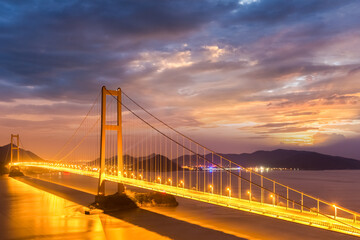 bridge spanning the sea in nightfall