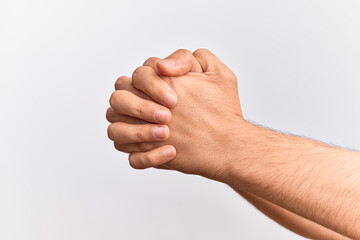 Hand of caucasian young man showing fingers over isolated white background praying with both hands clasped, fold fingers religious gesture