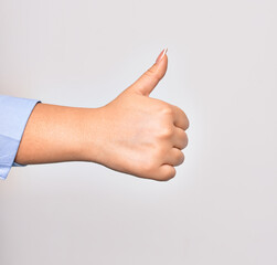 Hand of caucasian young woman doing ok sign with thumb up over isolated white background