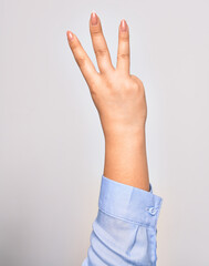 Hand of caucasian young woman showing number three with streched fingers raised up over isolated white background