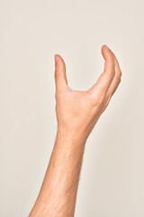 Hand of caucasian young man showing fingers over isolated white background picking and taking invisible thing, holding object with fingers showing space