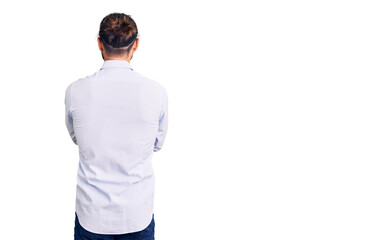 Young handsome man wearing business clothes standing backwards looking away with crossed arms