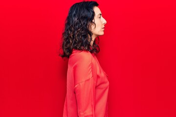 Fototapeta premium Young beautiful hispanic woman wearing casual clothes looking to side, relax profile pose with natural face with confident smile.