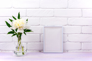 Fototapeta na wymiar White small frame mockup with peony in glass pitcher