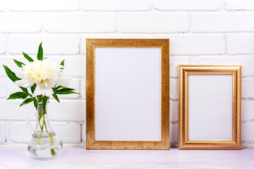 Two golden poster frames mockup with white peony