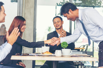 Team Business Partners shaking hands together to Greeting Start up small business in meeting room. Shakehand teamwork partners at modern office handshake together. Business mergers and acquisitions