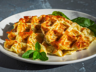 Zucchini shoes and fresh basil leaves on a gray plate close-up