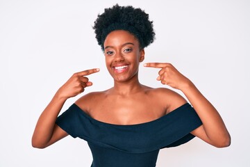 Young african american woman wearing casual clothes smiling cheerful showing and pointing with fingers teeth and mouth. dental health concept.