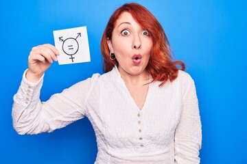 Redhead woman asking for sex discrimination holding paper with transgender equality message scared...