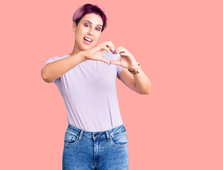 Young beautiful woman with pink hair wearing casual clothes smiling in love doing heart symbol shape with hands. romantic concept.