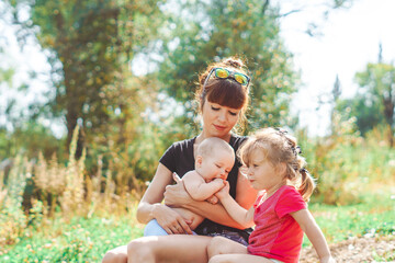 mother with children playing on a bench