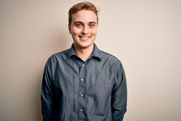 Young handsome redhead man wearing casual shirt standing over isolated white background with a happy and cool smile on face. Lucky person.