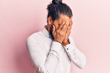 Young arab man wearing casual clothes with sad expression covering face with hands while crying. depression concept.