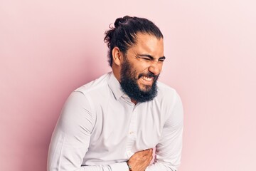 Obraz premium Young arab man wearing casual clothes with hand on stomach because nausea, painful disease feeling unwell. ache concept.