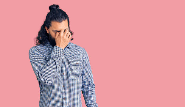 Young arab man wearing casual clothes tired rubbing nose and eyes feeling fatigue and headache. stress and frustration concept.