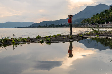 Young woman on a lake during sunset