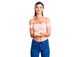 Young beautiful woman wearing casual clothes smiling with hands palms together receiving or giving gesture. hold and protection