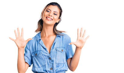 Young beautiful woman wearing casual clothes showing and pointing up with fingers number ten while smiling confident and happy.