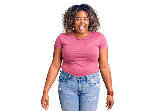 Young african american plus size woman wearing casual clothes sticking tongue out happy with funny expression. emotion concept.