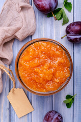 Yellow plum jam in a glass jar
