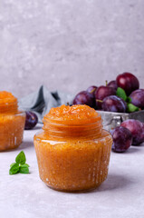Yellow plum jam in a glass jar