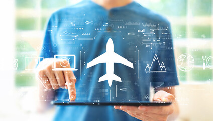 Flight ticket booking concept with young man using a tablet computer