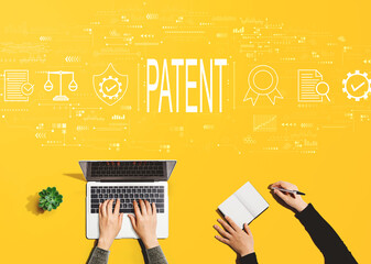 Patent concept with people working together with laptop and notebook