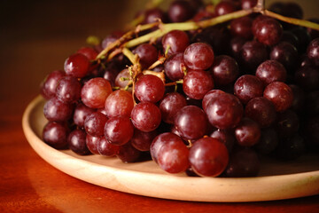 Fresh grapes on a wooden tray
