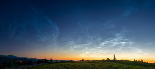Noctilucent clouds. Night glowing silvery clouds.  wide panorama.