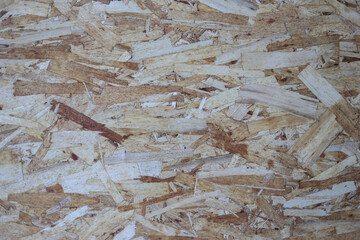 close-up details of the plywood surface overlap the wood chips.