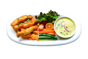 Fried fish sticks with coconut milk sauce and some vegetables decoration in plate isolated on white background. Fish fly in sticks decorative in dish with white sauce cream and vegetable