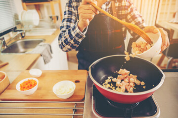 people preparing and cooking food in the home kitchen