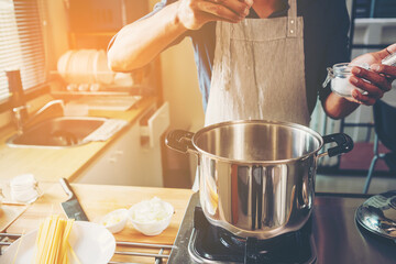people preparing and cooking food in the home kitchen