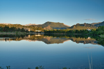 Fototapeta na wymiar Reflection on estes lake shows peaceful sunrise morning scene. Calm water gives reflection of the surrounding landscape