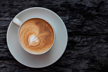 Fresh coffee in a ceramic mug On a wooden table