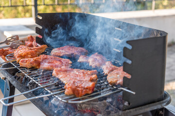 BBQ ribs. Ribs fried over an open fire. Fire and smoke roll meat.