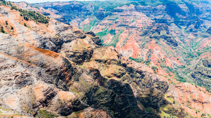 Jagged peaks in the valley of waimea canyon with water fall in the background