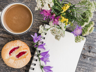 Cup of hot, aromatic coffee and a beautiful flowers. Close-up, view from above, indoors