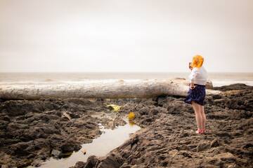 Woman on Oregon coast on a cloudy day. 